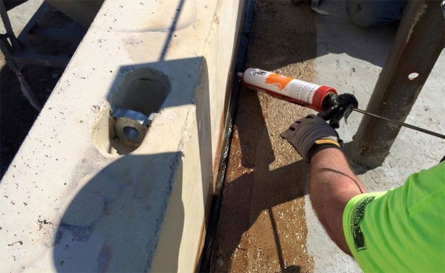 Workers from Restoration & Waterproofing Contractors, Inc. apply BEM.
